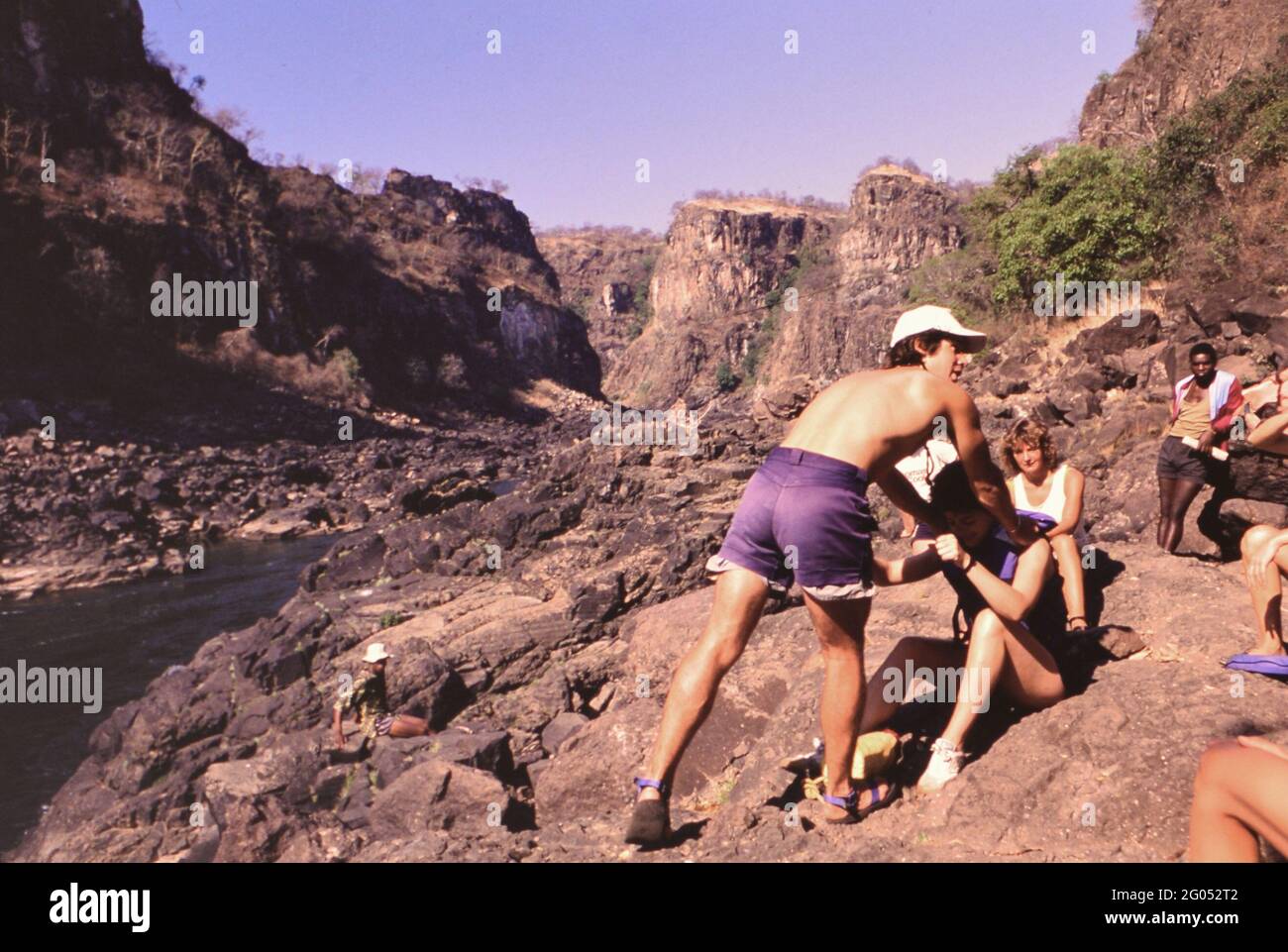 1990s Zimbabwe - Zambezi whitewater rafting guide demonstrates rescue ...