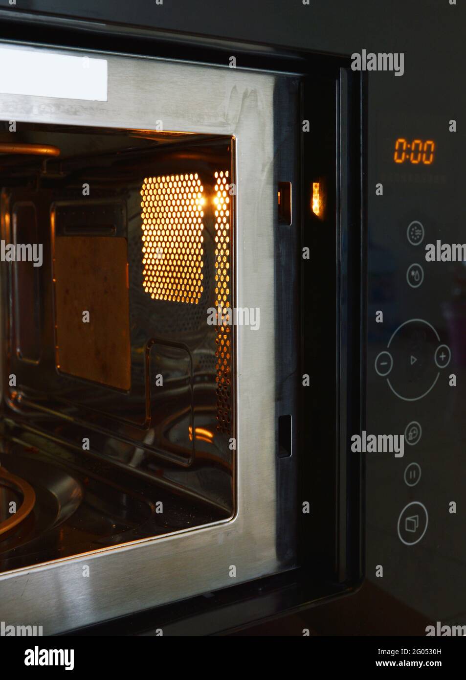 Microwave oven control panel and lighting inside Stock Photo Alamy
