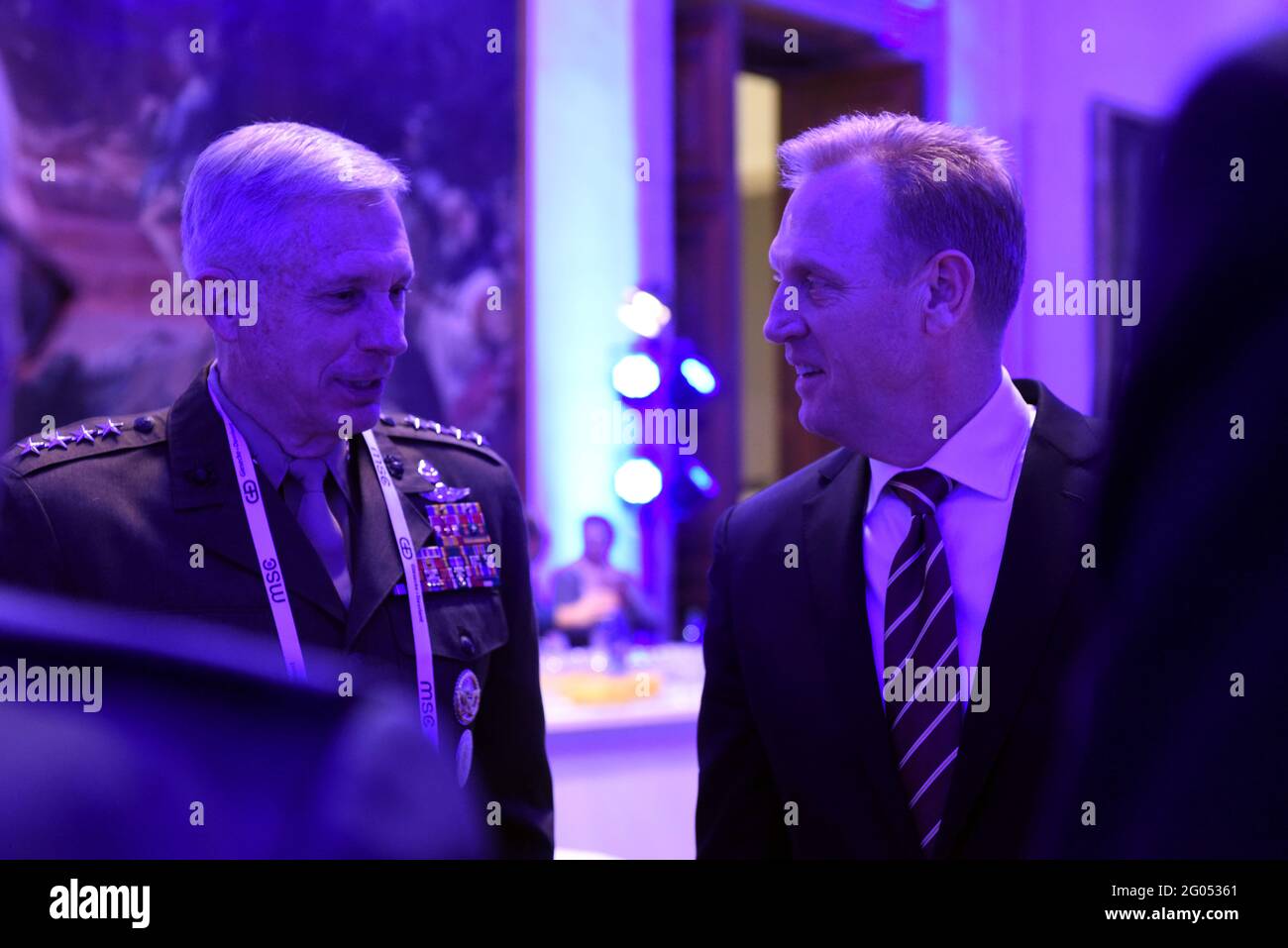 Reportage:   U.S. Acting Secretary of Defense Patrick M. Shanahan speaks with the commander of United States Africa Command, Marine Corps Gen. Thomas Waldhauser at the Munich Security Conferenceâ€™s Inaugural John McCain Award Ceremony, Munich, Germany, Feb. 15, 2019. Stock Photo