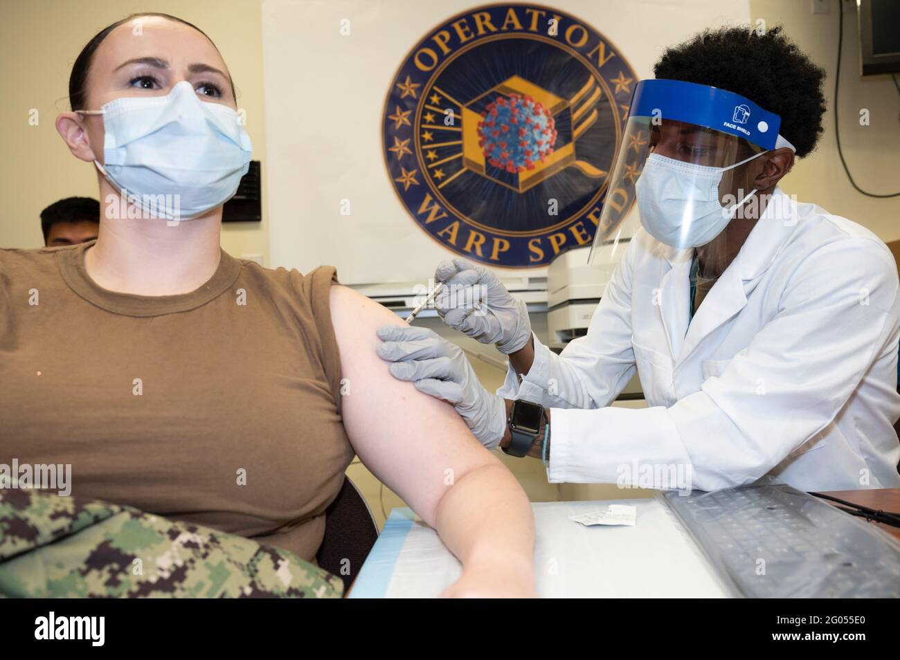 Reportage:  Navy Petty Officer 2nd Class Blythe Turney, a hospital corpsman at Walter Reed National Military Medical Center, receives a COVID-19 vaccination, Walter Reed National Military Medical Center, Bethesda, Md., Dec. 14, 2020. Stock Photo