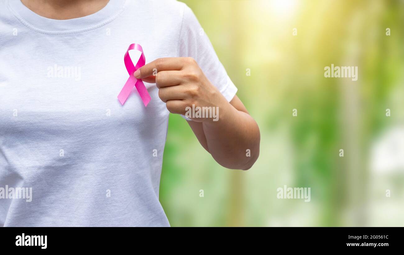 Women holding pink ribbons educating breast cancer awareness, healthcare concepts and breast cancer symbols. Stock Photo