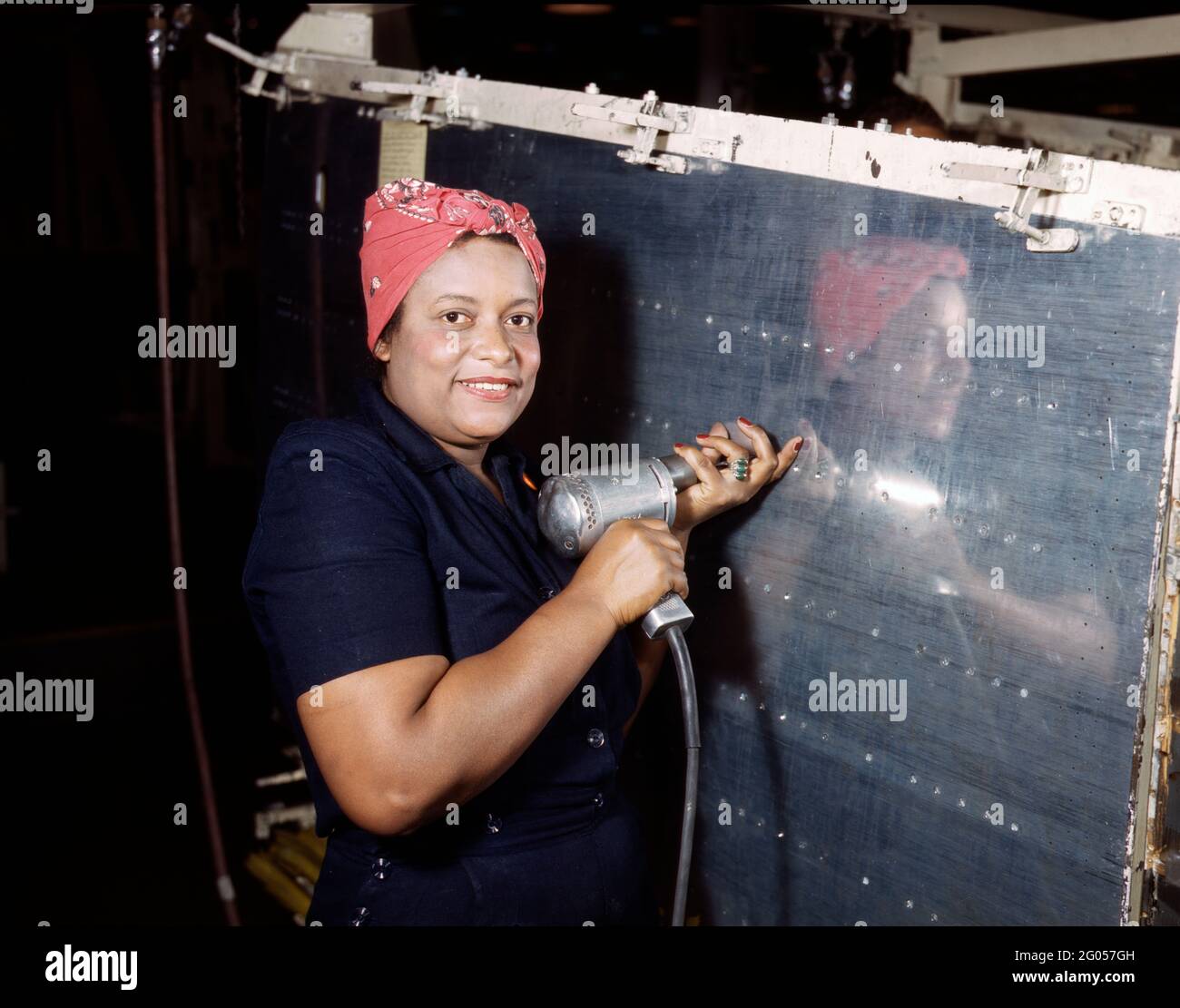 Operating a hand drill at Vultee-Nashville, woman is working on a 'Vengeance' dive bomber, Tennessee, February 1943 Stock Photo