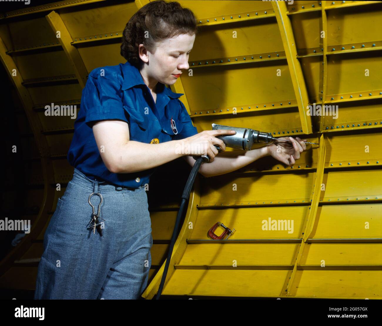 Operating a hand drill at Vultee-Nashville, woman is working on a Vengeance dive bomber, Tennessee, February 1943 Stock Photo