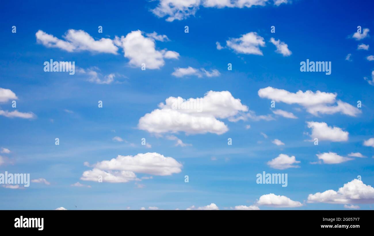 Cumulus white clouds floating in blue sky, concept for design to make wallpaper. Stock Photo