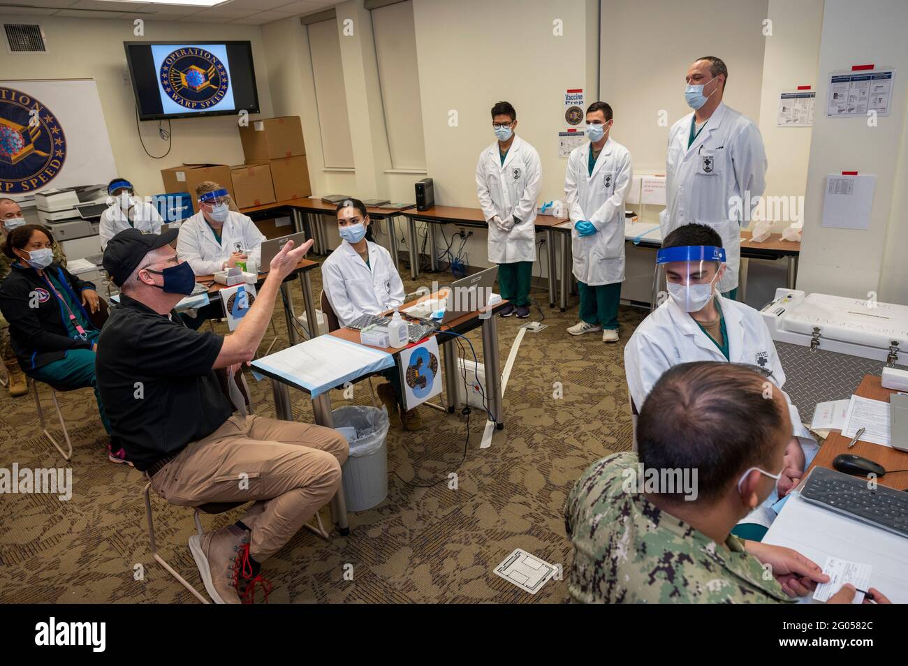 Reportage:  Acting Defense Secretary Chris Miller talks with medical staff at Walter Reed National Military Medical Center after receiving a vaccination for COVID-19, Bethesda, Md., Dec. 14, 2020. Stock Photo