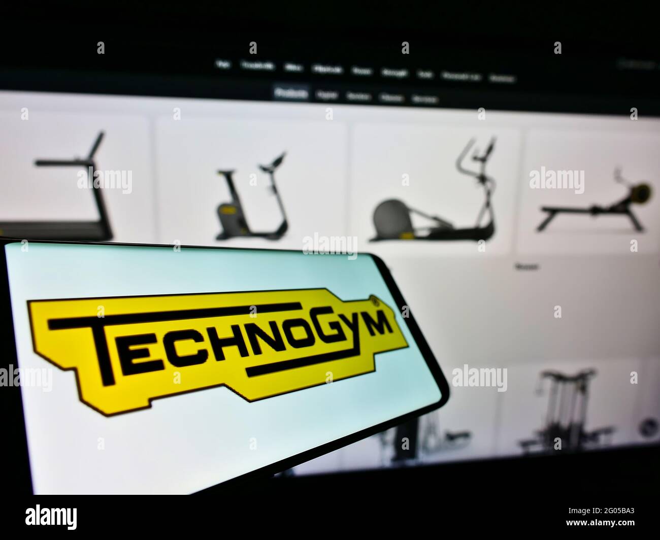 Smartphone with logo of Italian fitness equipment company Technogym S.p.A. on screen in front of business website. Focus on center of phone display. Stock Photo