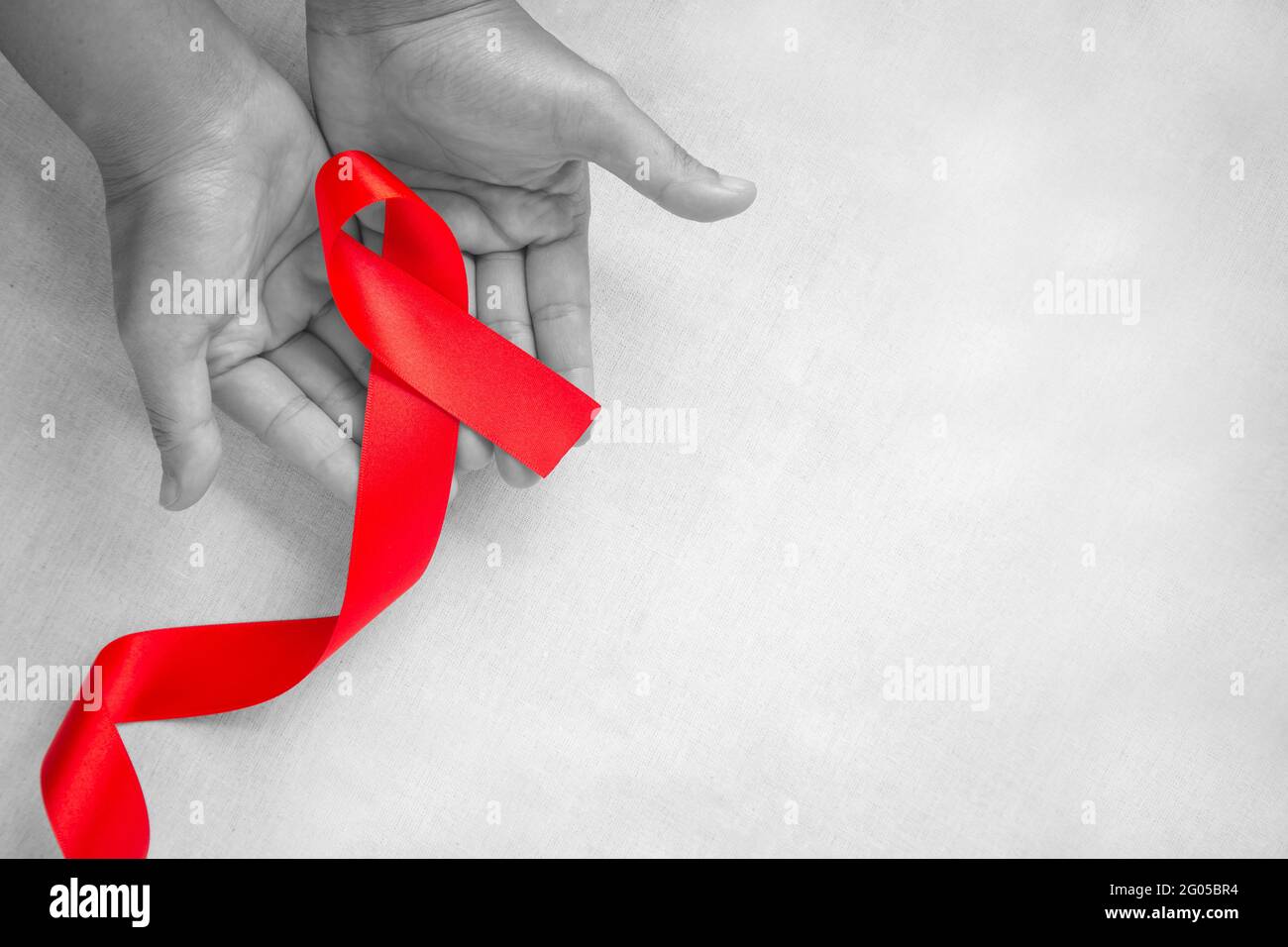 Hand holding Red ribbon on white background with copy space, the ...