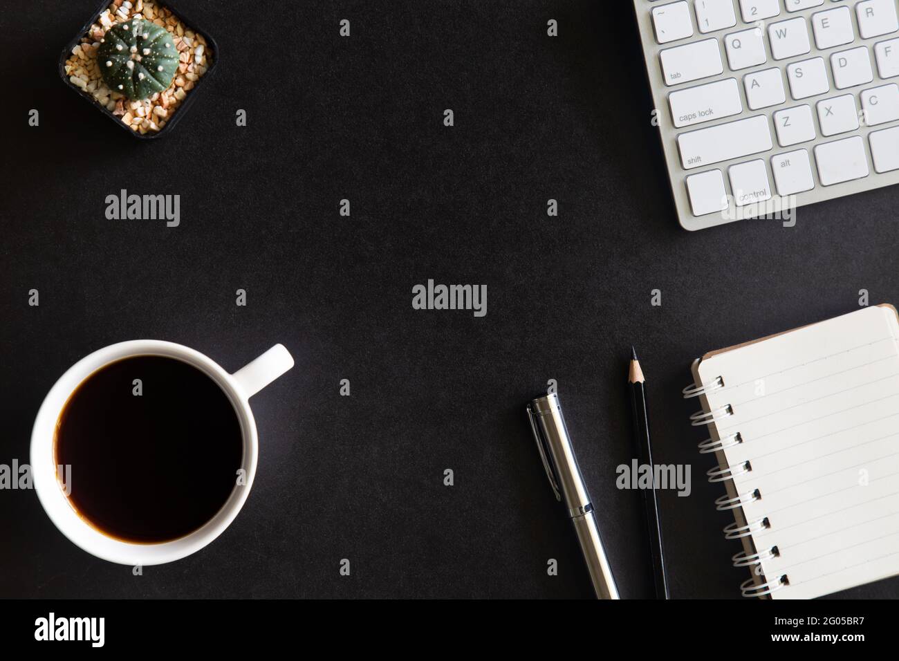 Black desk office with laptop, smartphone and other work supplies with cup of coffee. Top view with copy space for input the text. Designer workspace Stock Photo