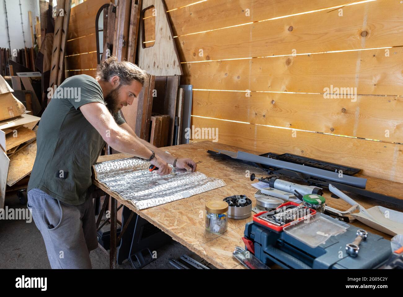 Man using a knife on a workbench Stock Photo