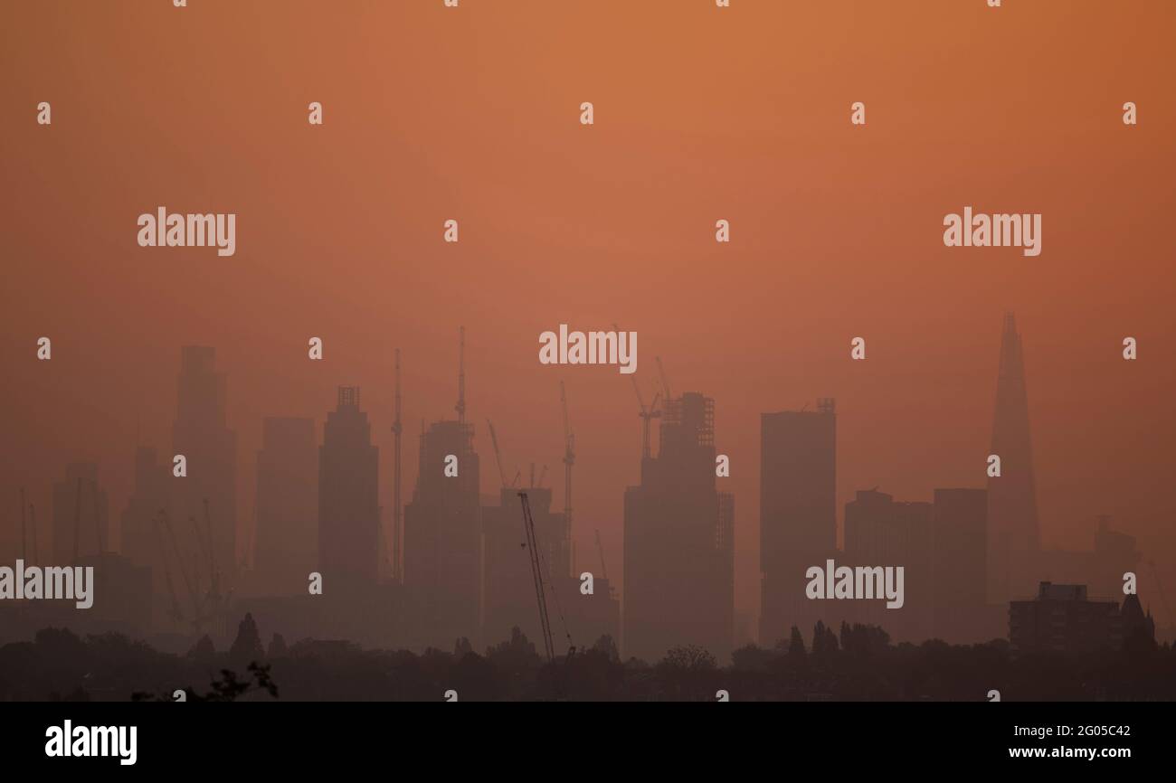 London, UK. 1 June 2021. Hazy orange dawn sky colours the skyscrapers in central London as a mini-heatwave continues in the capital. Credit: Malcolm Park/Alamy Live News. Stock Photo