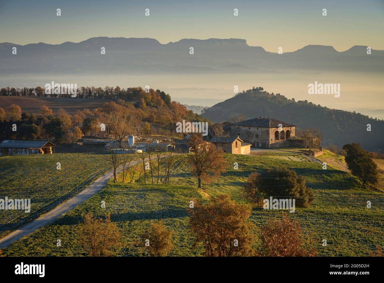 Sunrise in Sant Bartomeu del Grau village, with the El Pujol country house in the foreground (Osona, Catalonia, Spain) Stock Photo