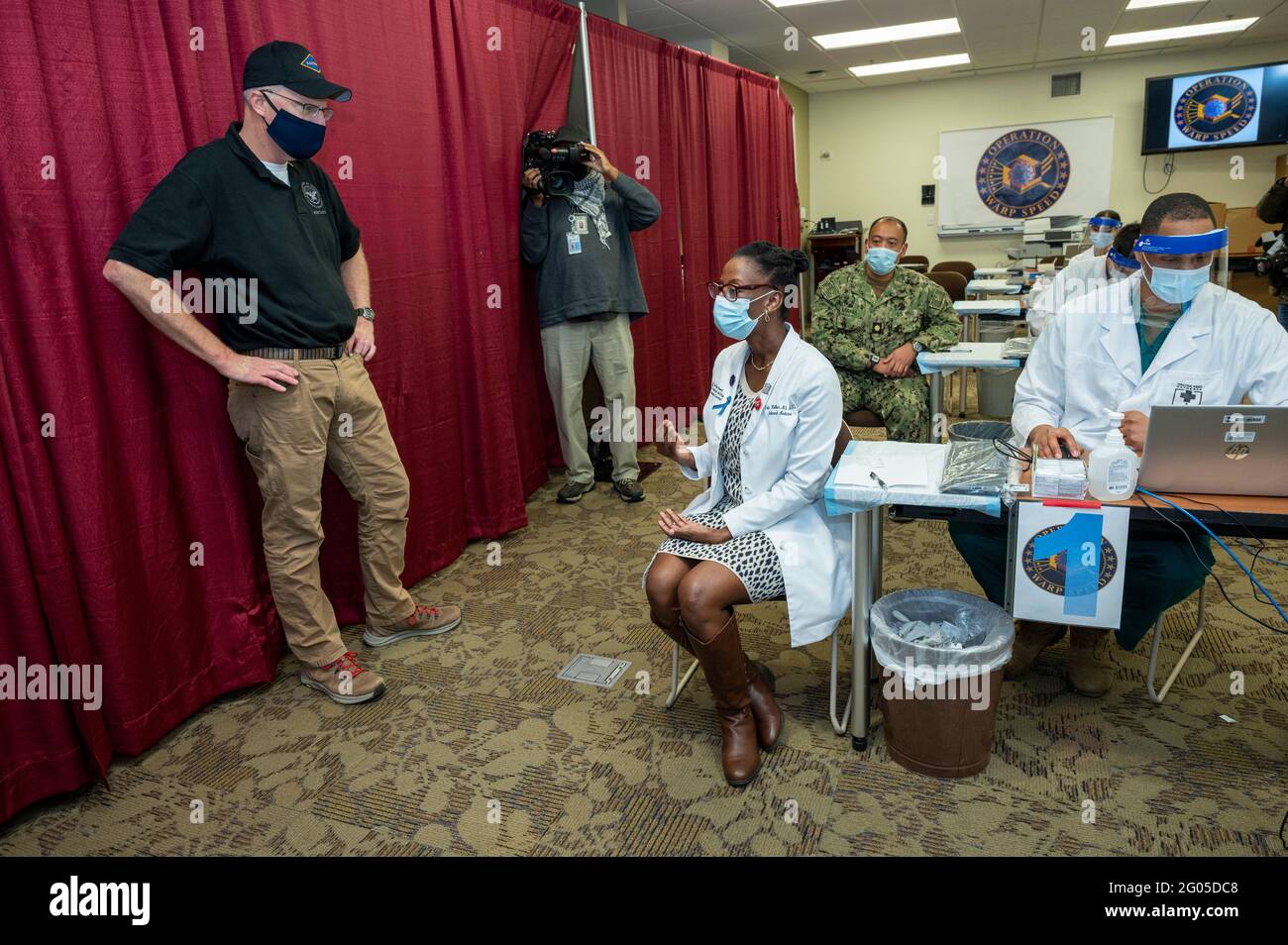 Reportage:  Acting Defense Secretary Chris Miller talks to Dr. Erika Walker, Department of Medicine at Walter Reed National Military Medical Center, after she was vaccinated for COVID-19,  Walter Reed National Military Medical Center, Bethesda, Md., Dec. 14, 2020. Stock Photo