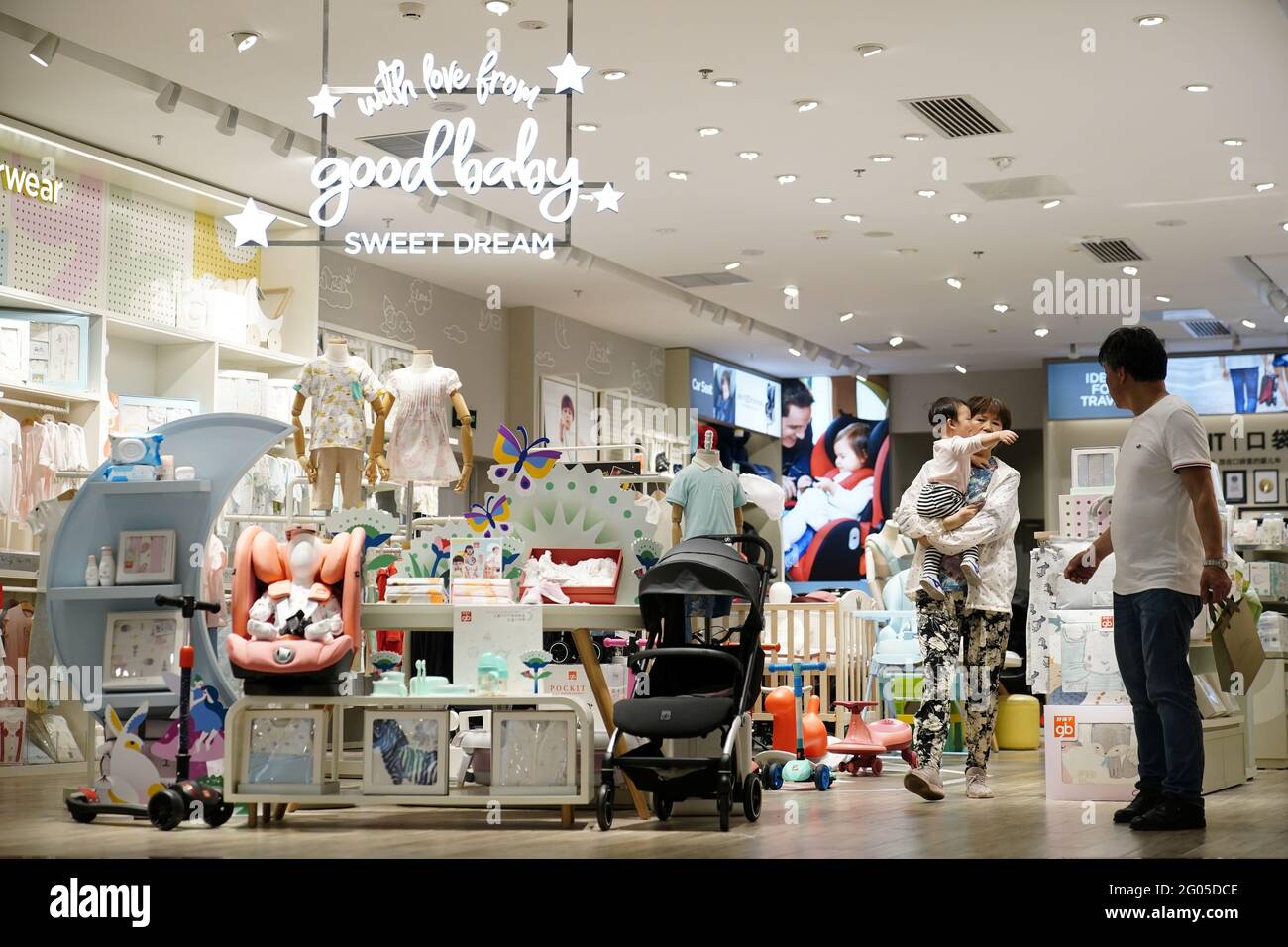 An Adult Holding A Baby Walks At A Store Selling Baby Products In Shanghai China June 1 21 Reuters Aly Song Stock Photo Alamy