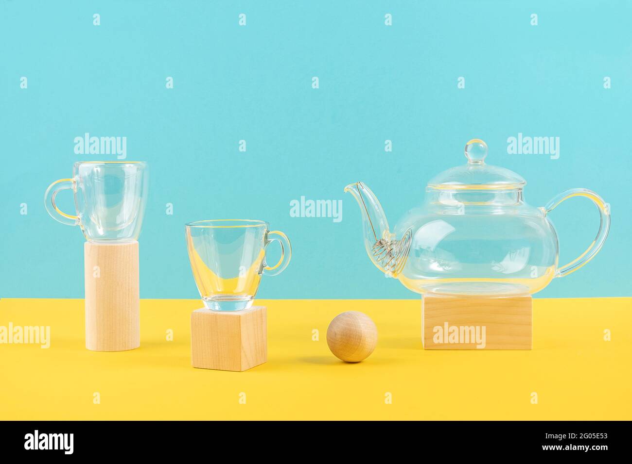 Empty glass transparent tea set. Teapot and and two cups standing on ...