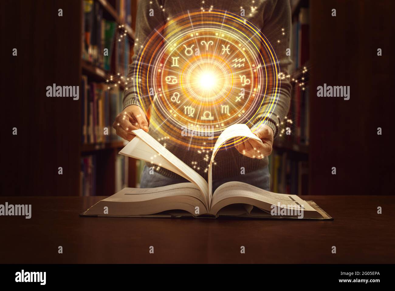 Woman reading a astrology book. Astrological wheel projection, choose a zodiac sign. Trust horoscope future predictions, consulting stars. Power of un Stock Photo