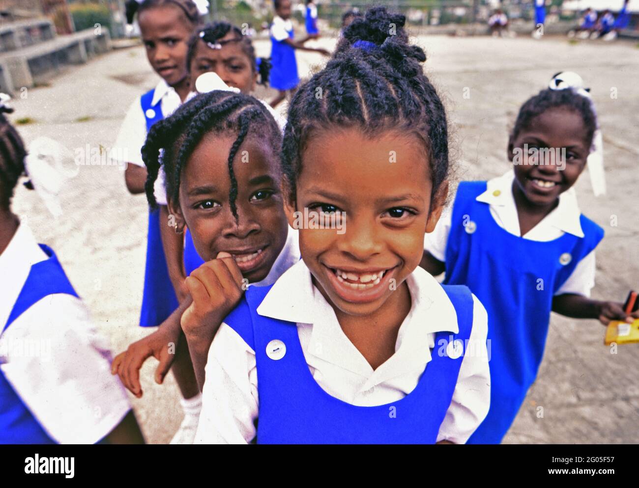 1990s Grenada - Local smiling schoolgirls in Catholic school uniforms return after lunch ca. 1998 Stock Photo