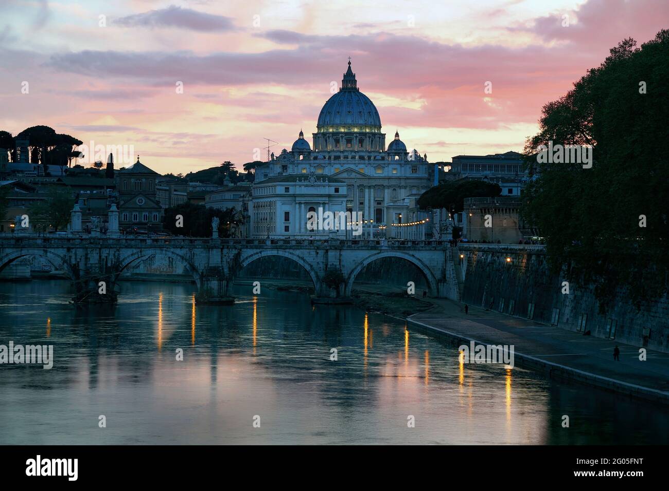 Rome, Italy.  Sant'Angelo bridge and St Peter's Basilica at dusk.  The historic centre of Rome, including the Vatican, are a UNESCO World Heritage Sit Stock Photo