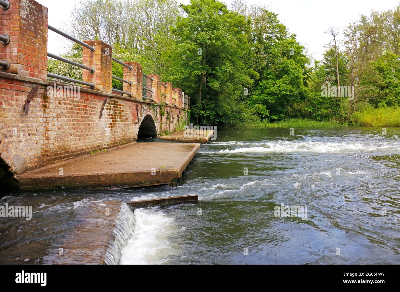 A view of the River Bure and 18th century brick arches remaining from the burnt down watermill at Horstead, Norfolk, England, United Kingdom. Stock Photo