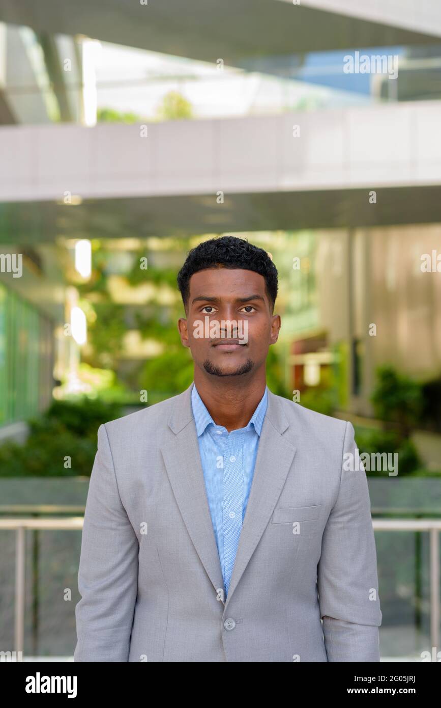 Portrait of handsome young African businessman wearing suit Stock Photo ...