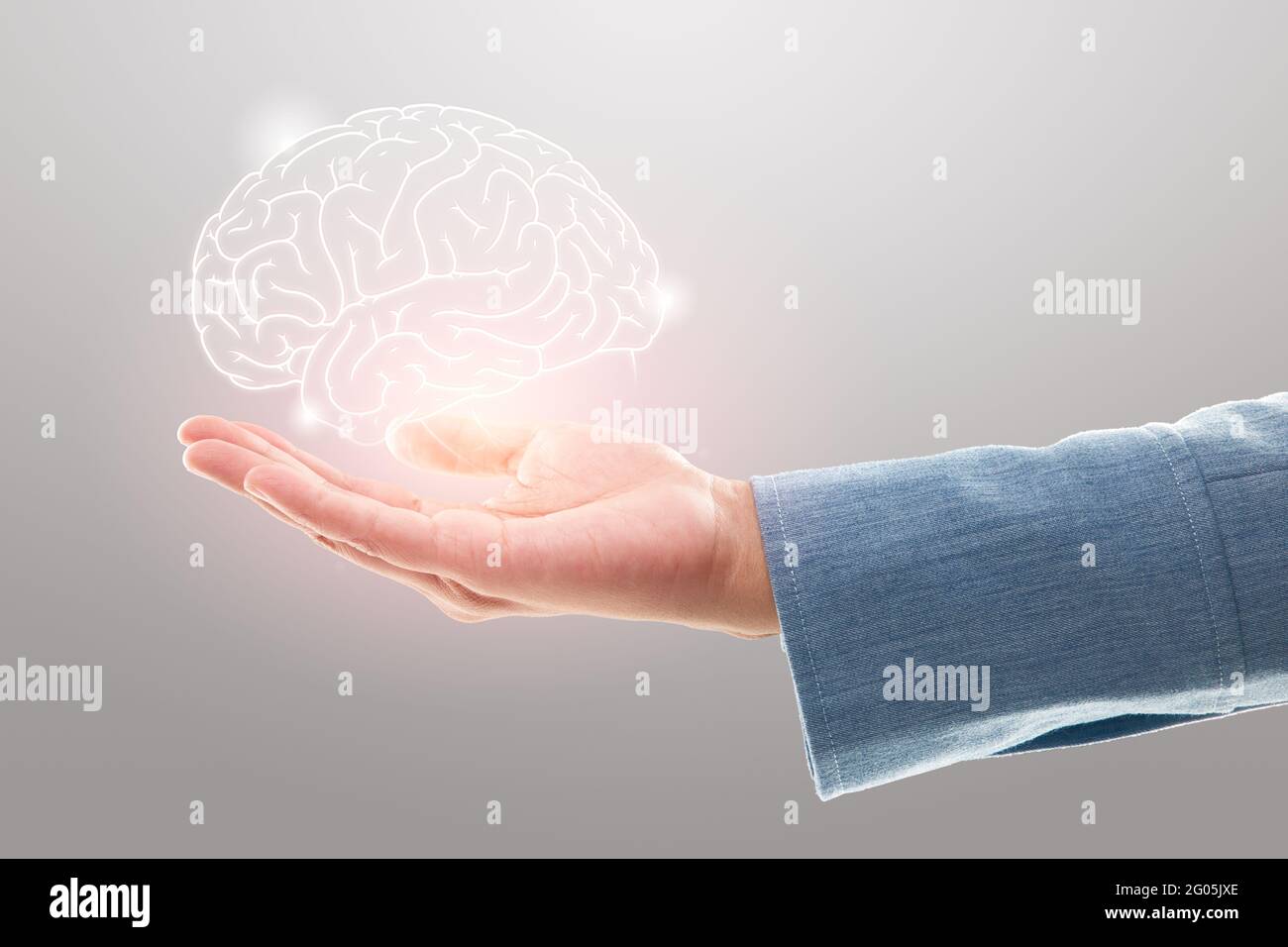Female doctor holding brain illustration against the gray background. Mental health protection and care Stock Photo