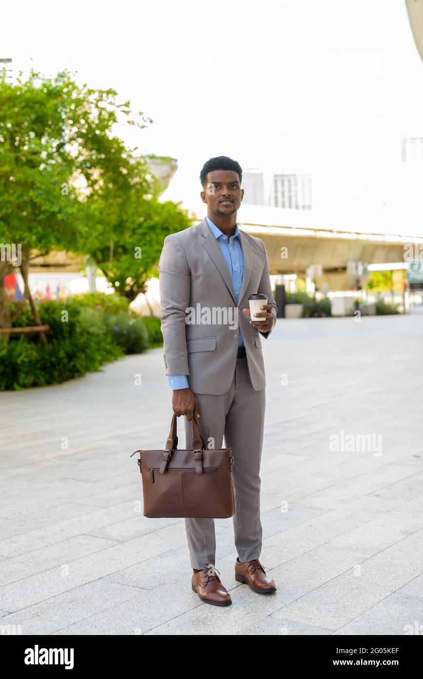 Portrait of handsome young African businessman wearing suit Stock Photo ...