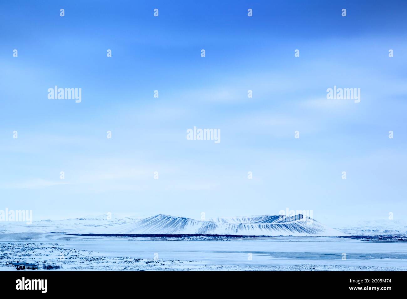 Hverfjall volcano snow covered in winter viewed from across a frozen lake Myvatn Stock Photo