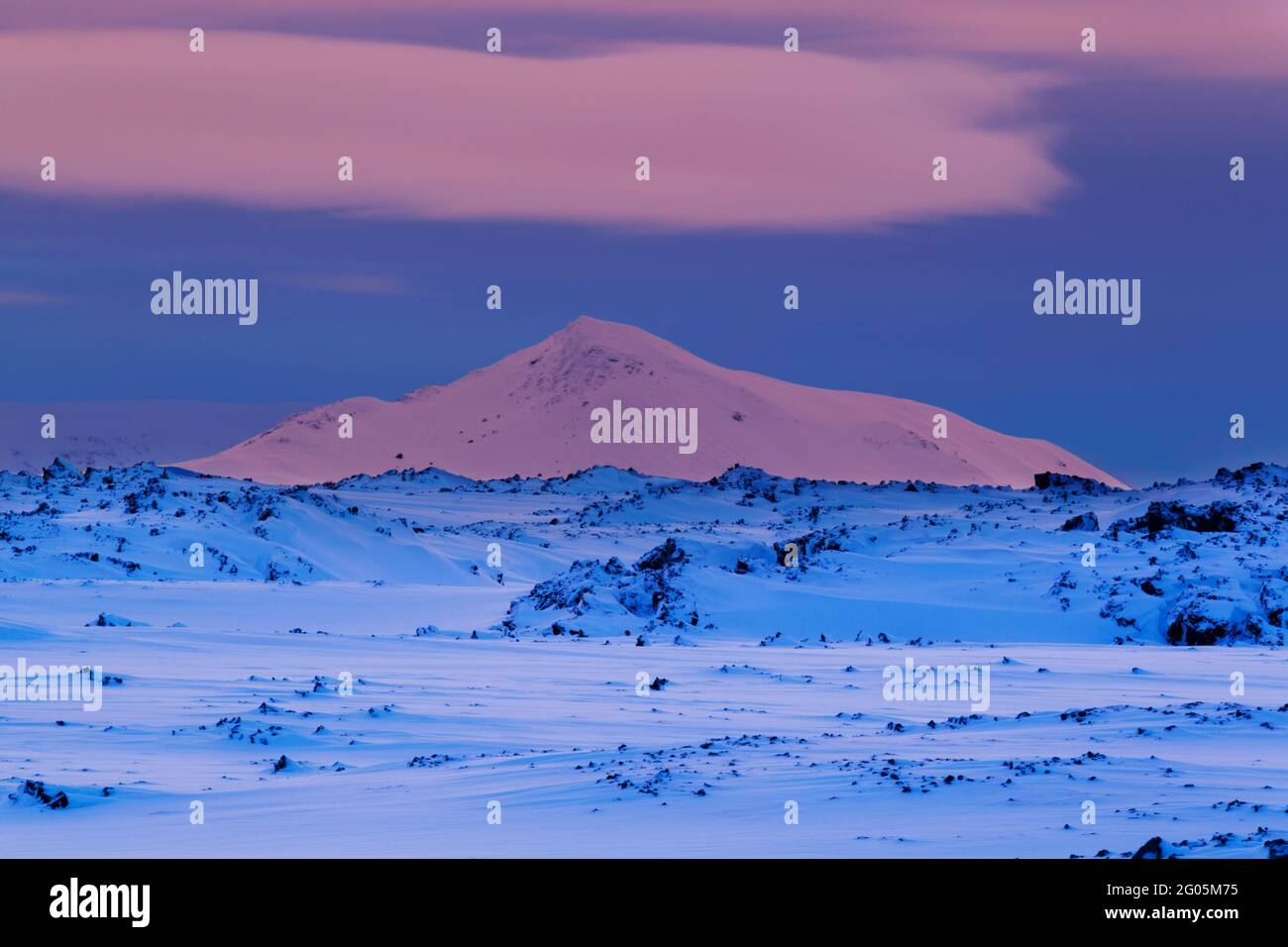 Colourful lighting at daybreak over the Námafjall region close to Hverfjall in northern Iceland during winter looking towards the Myvatnsoraefi montan Stock Photo