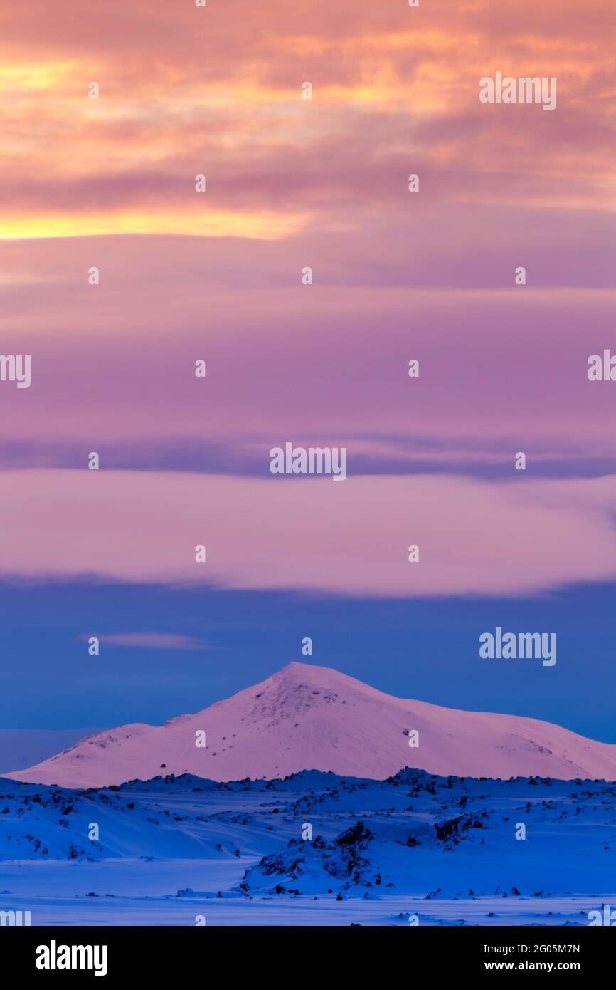 Colourful lighting at daybreak over the Námafjall region close to Hverfjall in northern Iceland during winter looking towards the Myvatnsoraefi montan Stock Photo