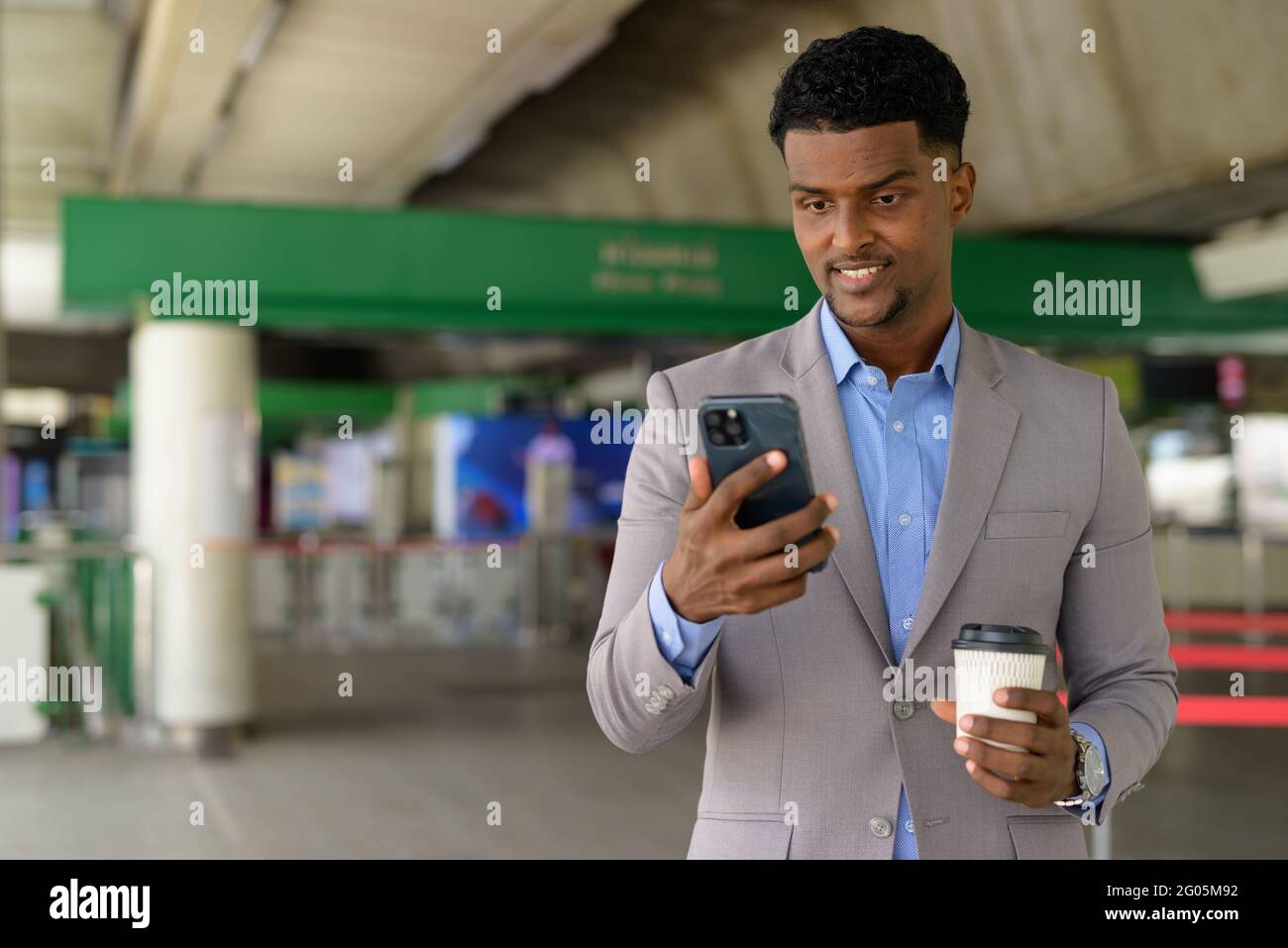 Portrait of handsome young African businessman wearing suit Stock Photo ...