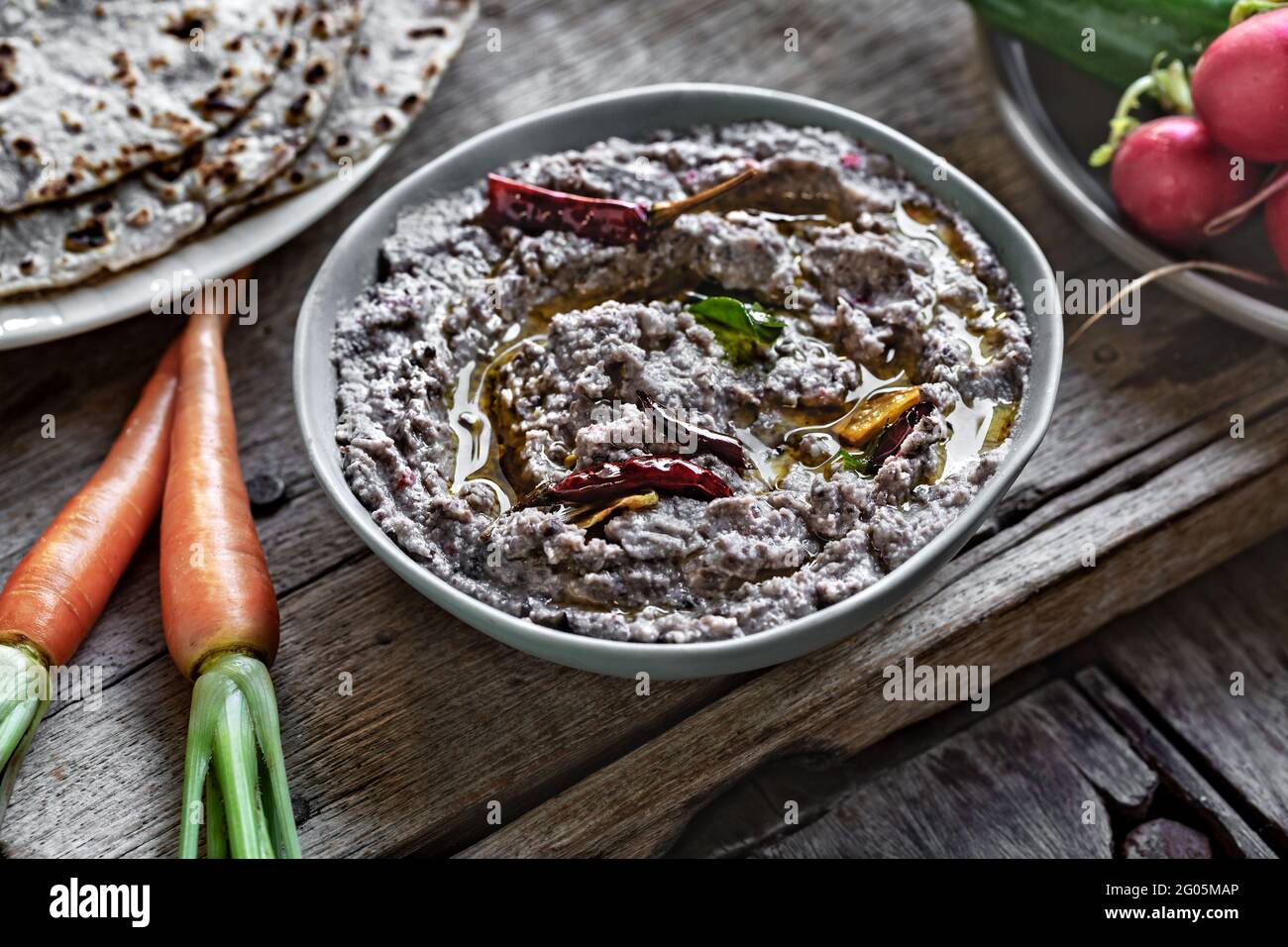 Homemade Black Bean Dip with Hebs Olive Oil ,Dried Chili by Sweet Purple Potato Tortilla and  fresh vegetables Stock Photo