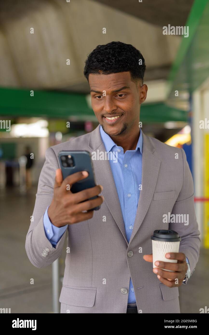 Portrait of handsome young African businessman wearing suit Stock Photo ...