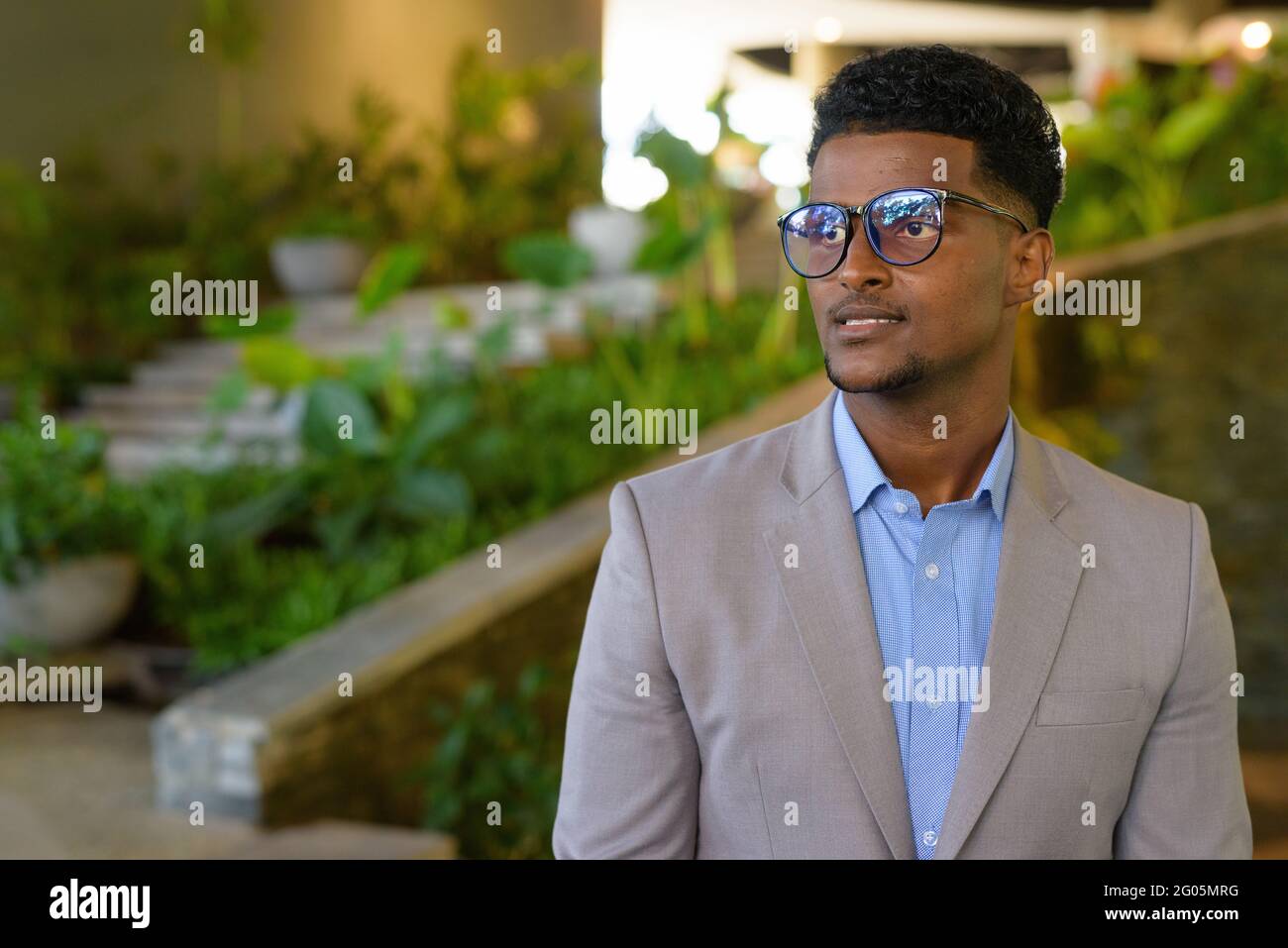 Portrait of handsome young African businessman wearing suit Stock Photo ...