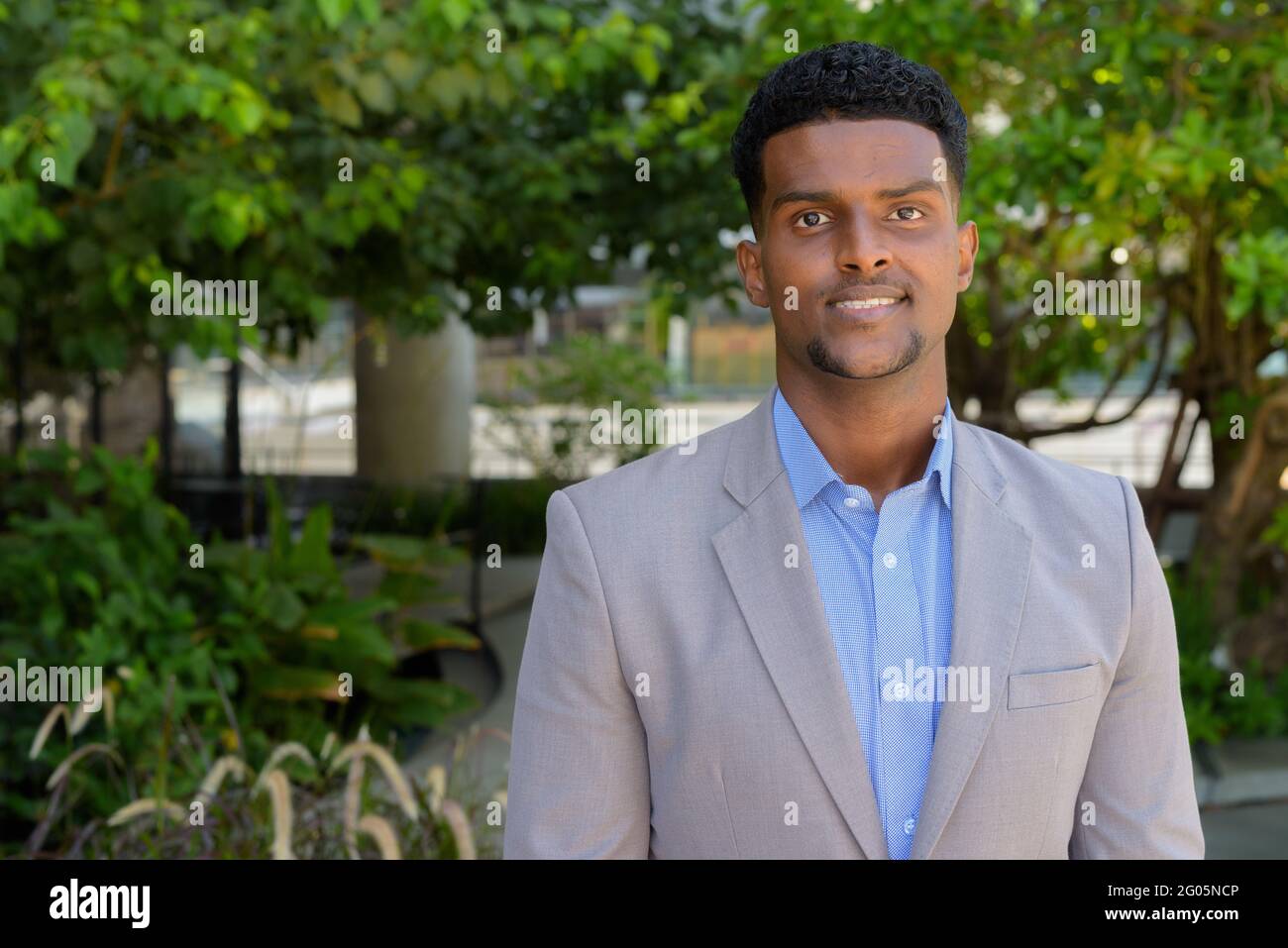 Portrait of handsome young African businessman wearing suit Stock Photo ...