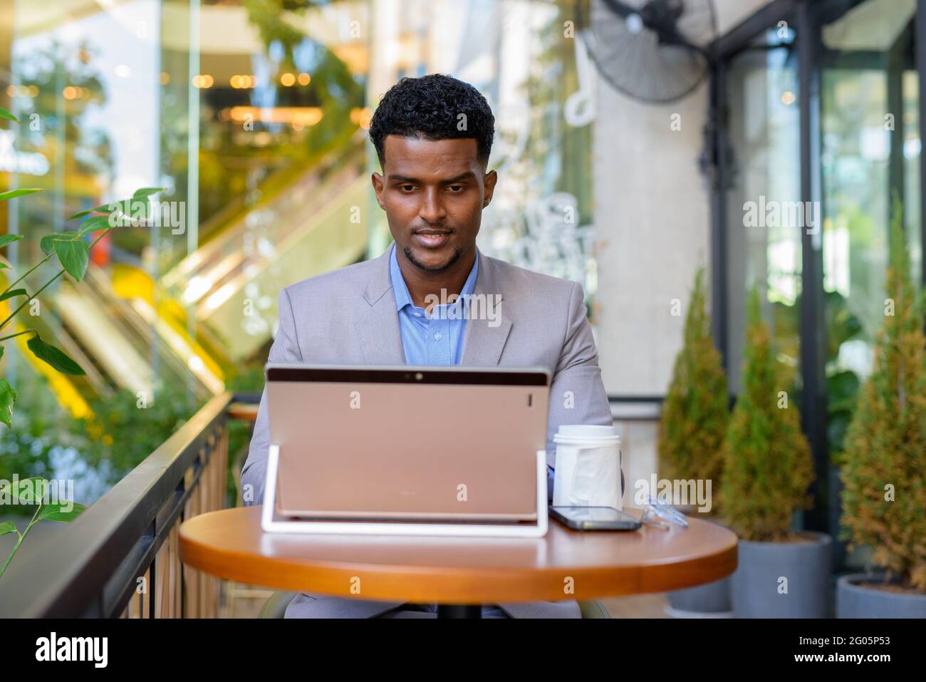 Portrait of handsome young African businessman wearing suit Stock Photo ...