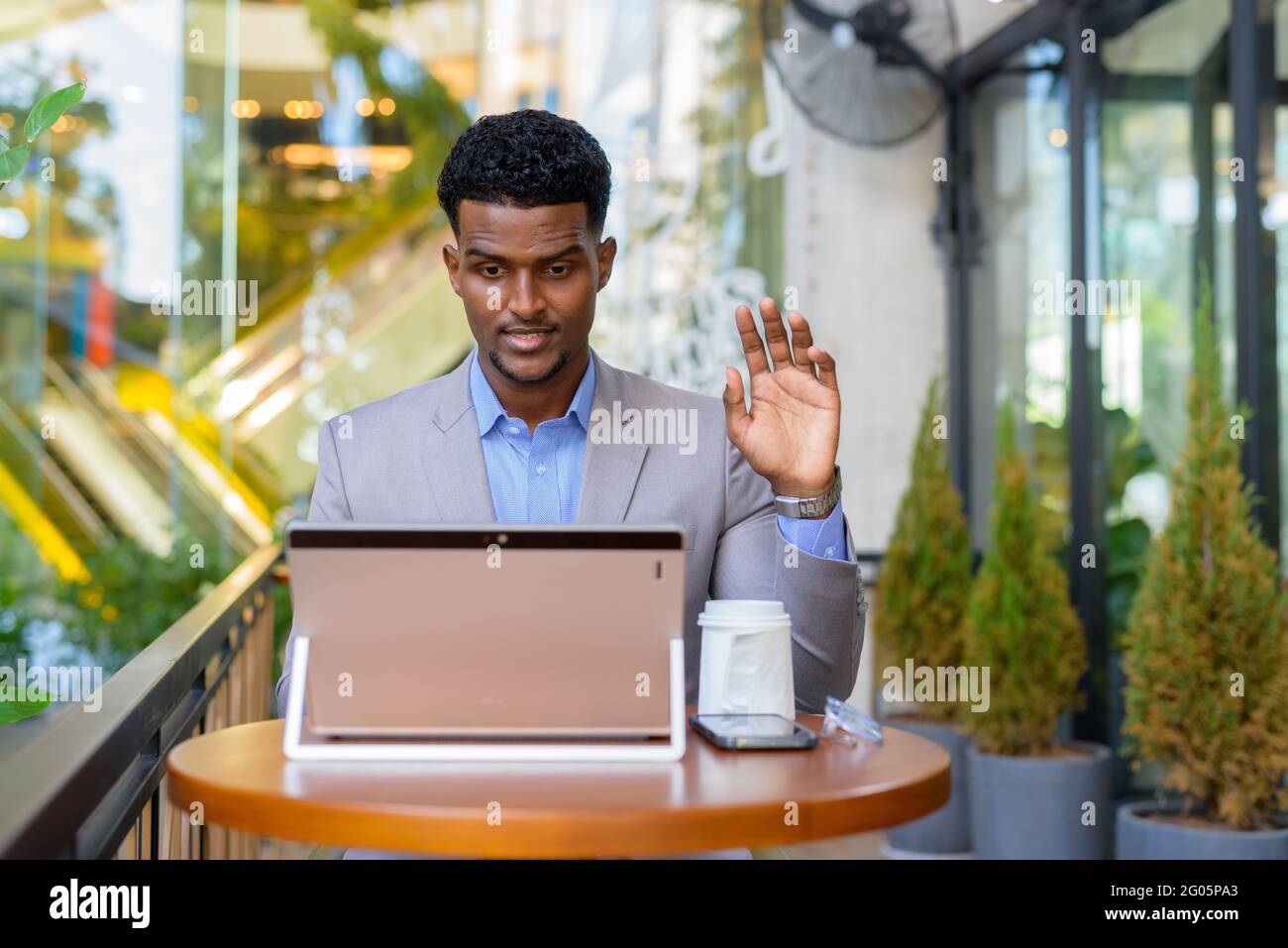 Portrait of handsome young African businessman wearing suit Stock Photo ...