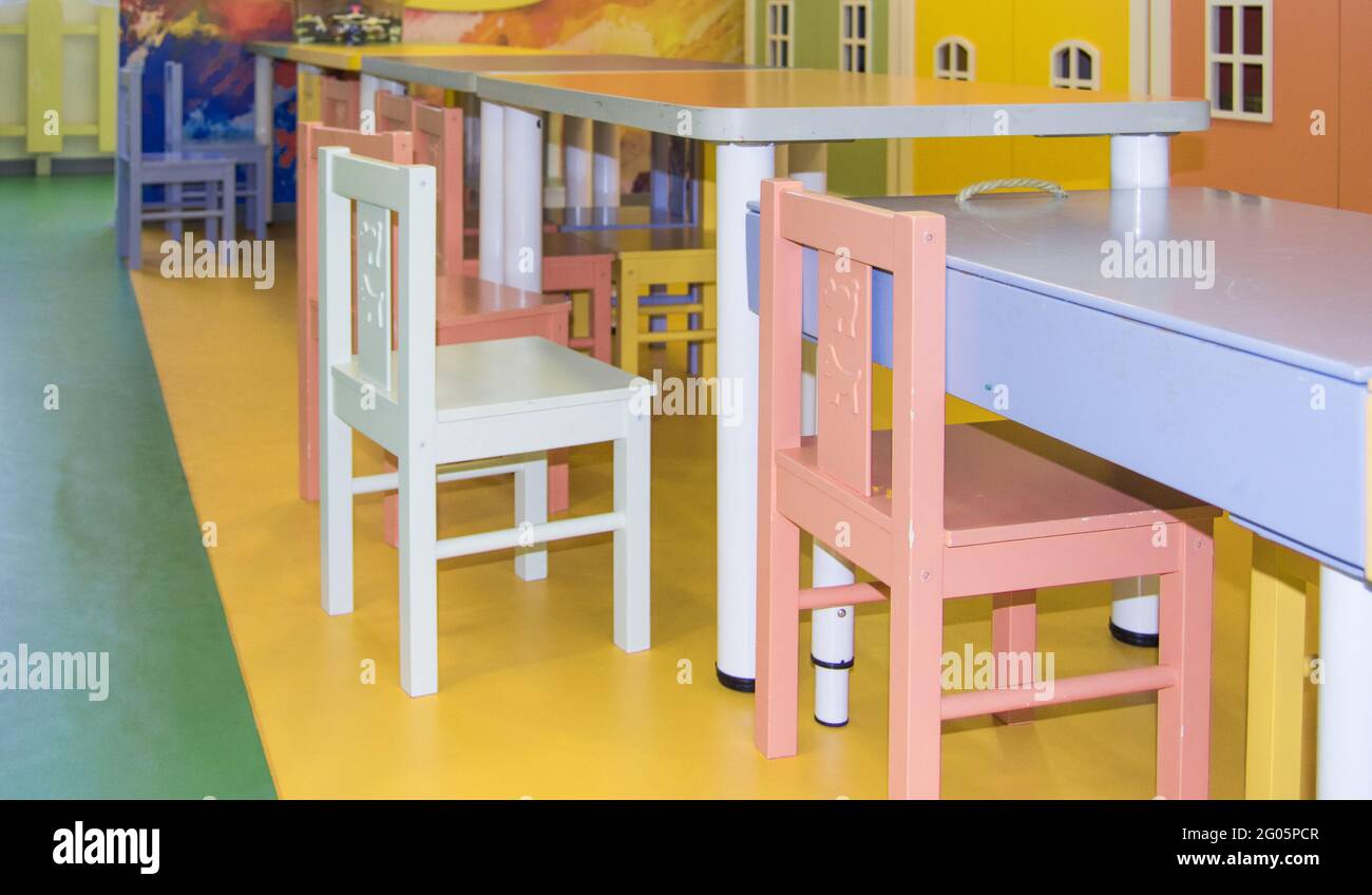A set of cute children's tables and high chairs in the kindergarten