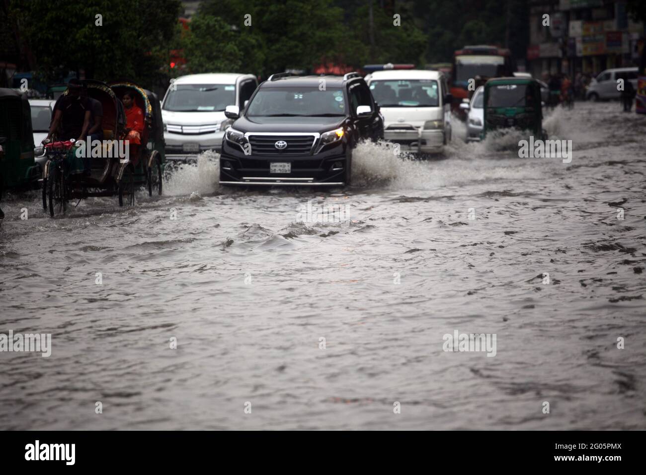 Jun 01, 2021.Dhaka,Bangladesh. Vehicles pass through a flooded street