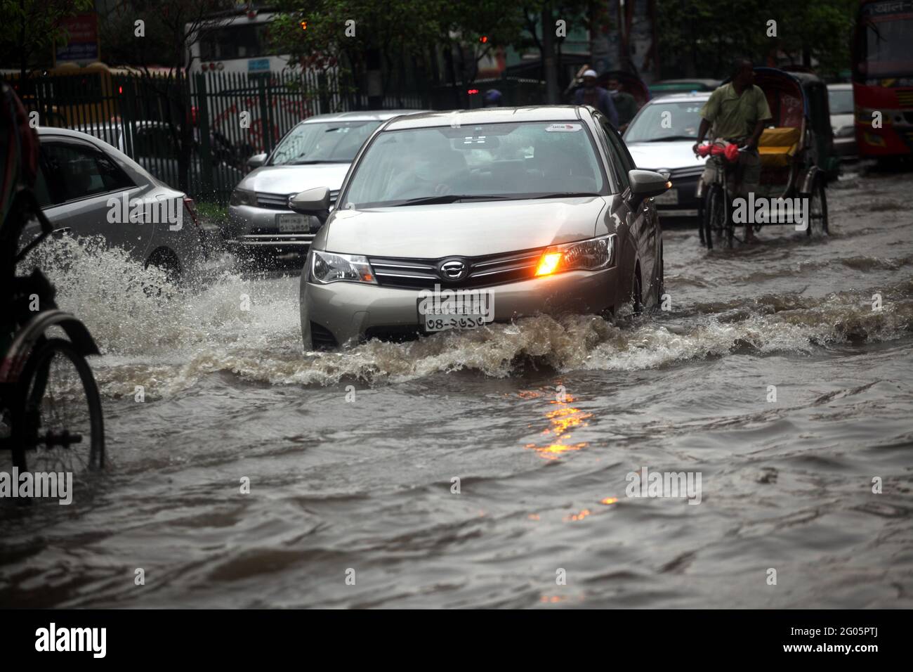 Jun 01, 2021.Dhaka,Bangladesh. Vehicles pass through a flooded street