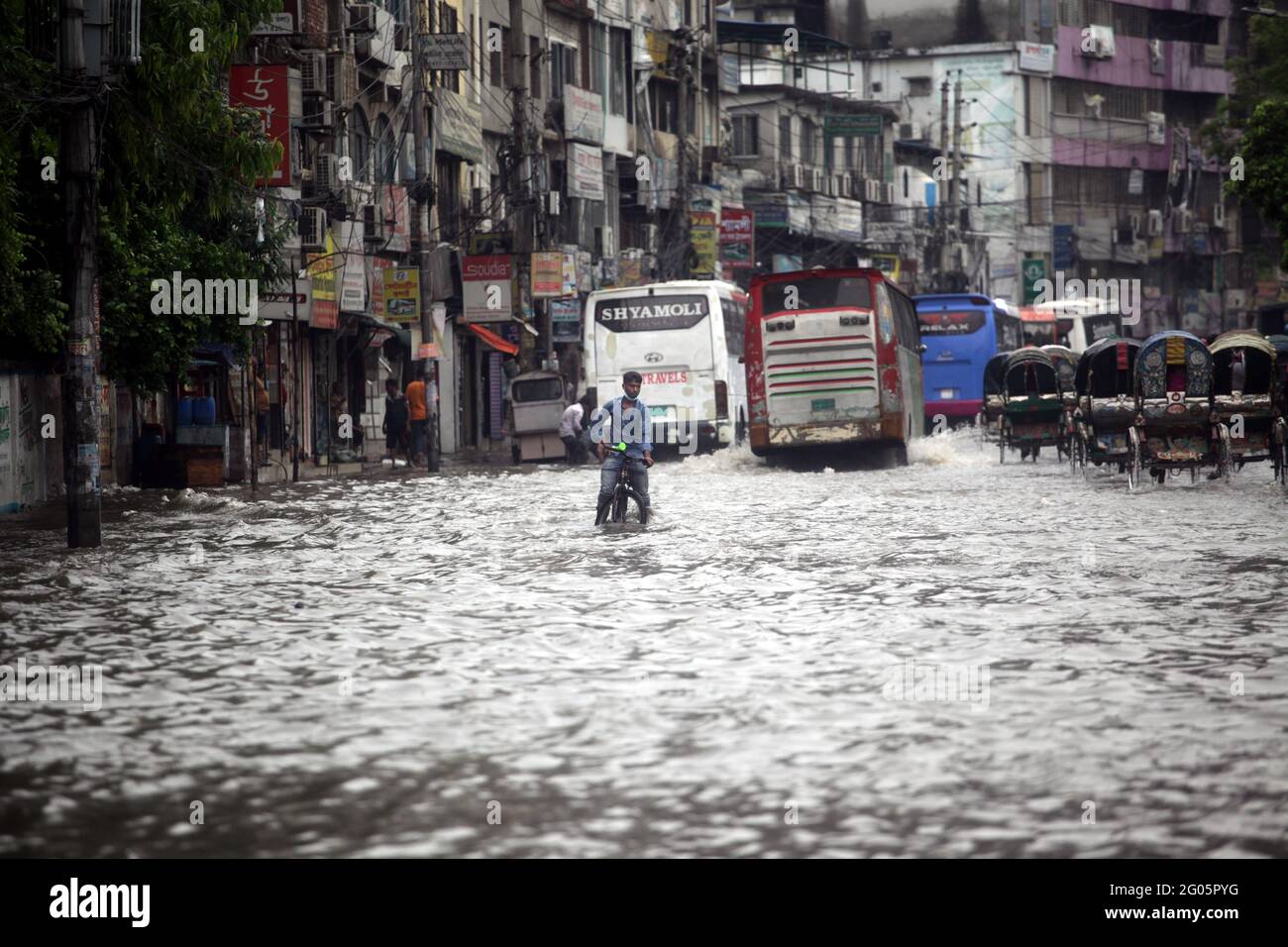 Jun 01, 2021.Dhaka,Bangladesh. Vehicles pass through a flooded street