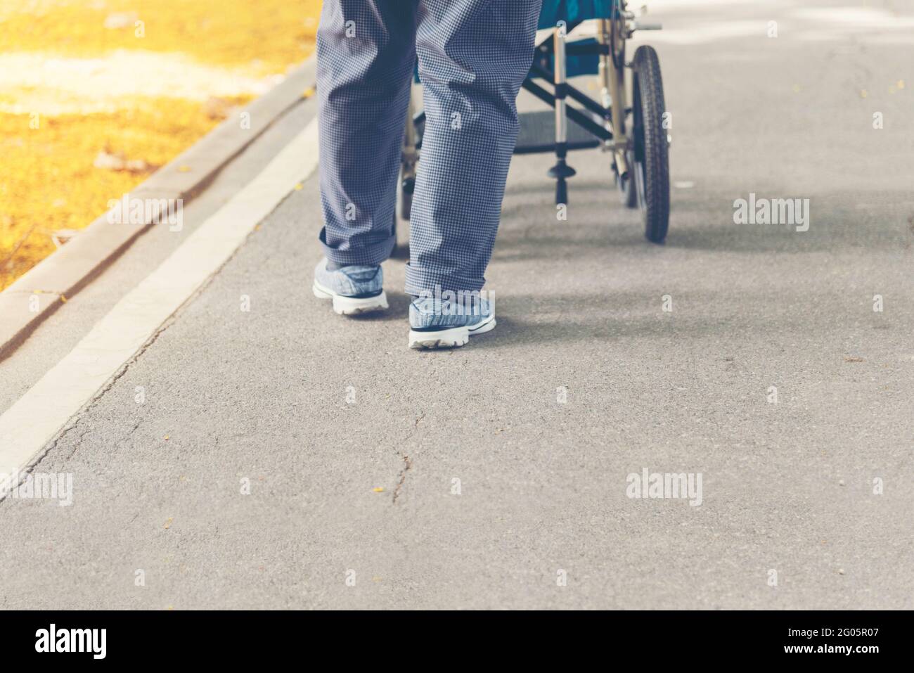 Senior woman try to exercise by walk around the park by using