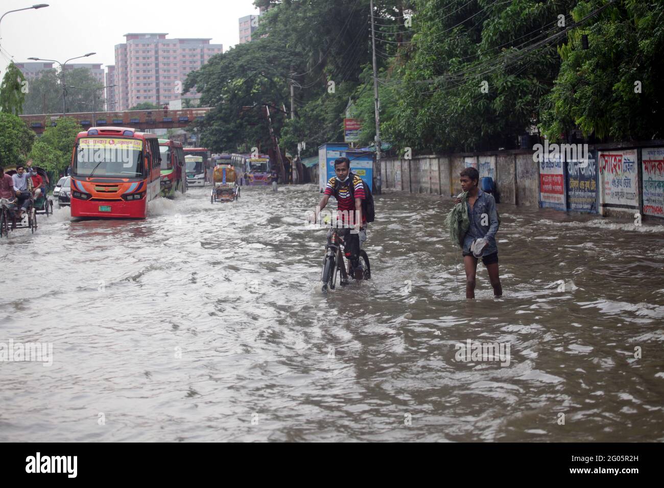 Jun 01, 2021.Dhaka,Bangladesh. Vehicles pass through a flooded street