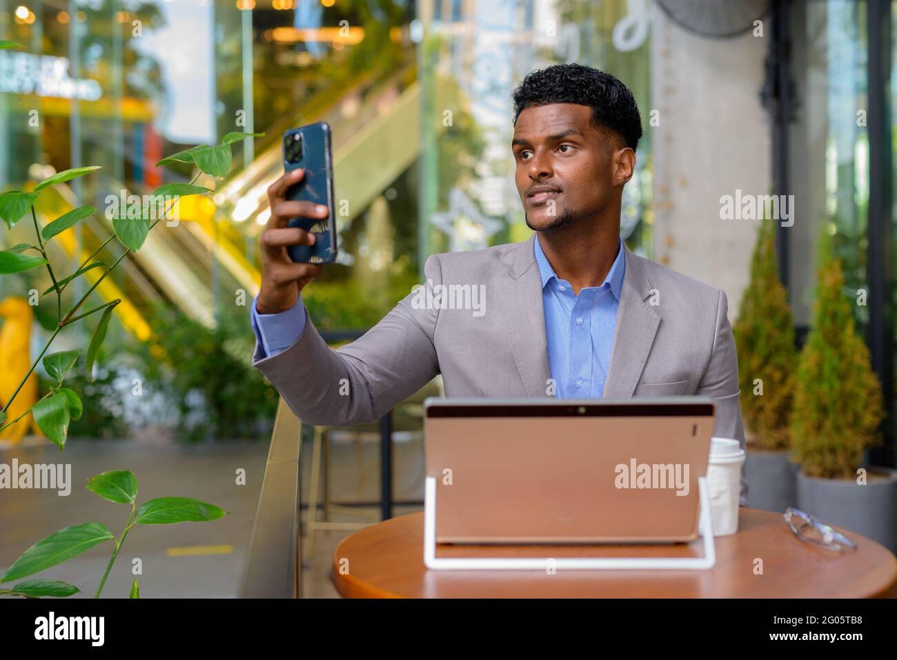 Portrait of handsome young African businessman wearing suit Stock Photo ...