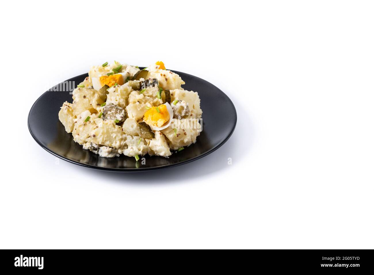 Potato salad with gherkings, egg and mustard isolated on white