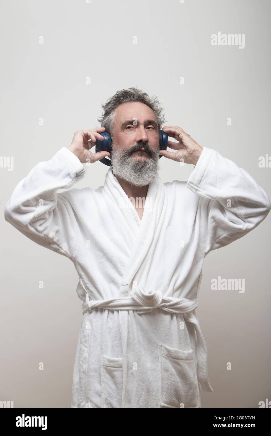 older man listening to music in bathrobe Stock Photo Alamy