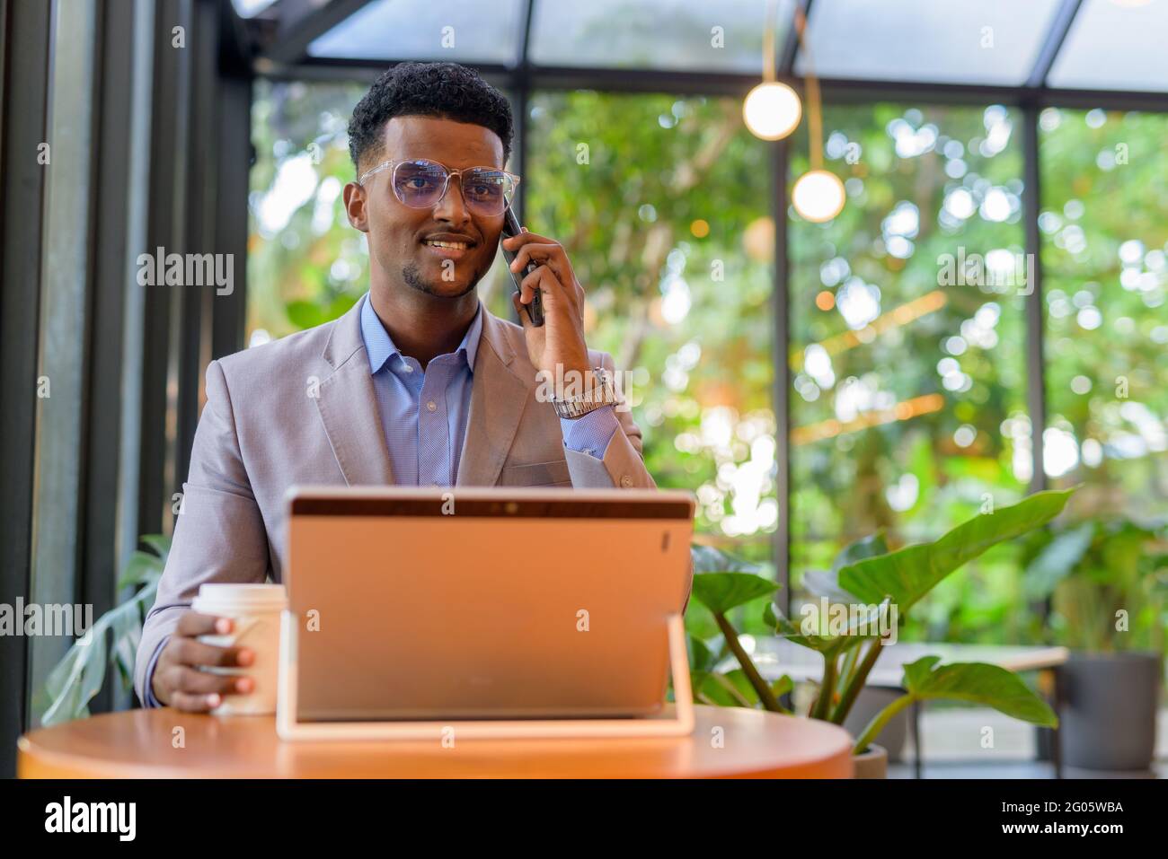 Portrait of handsome young African businessman wearing suit Stock Photo ...
