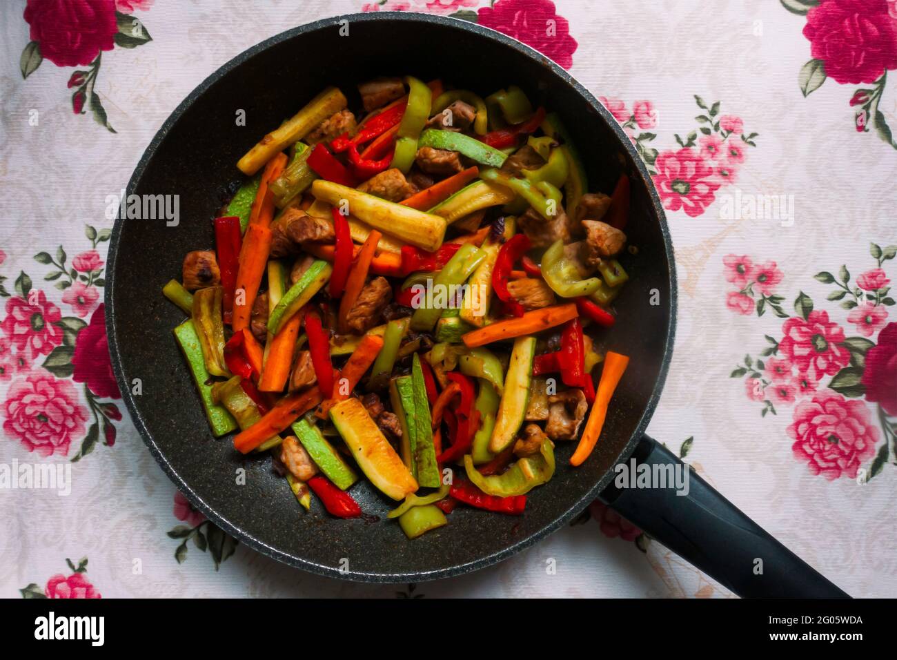 meat with vegetables in a pan on a table Stock Photo
