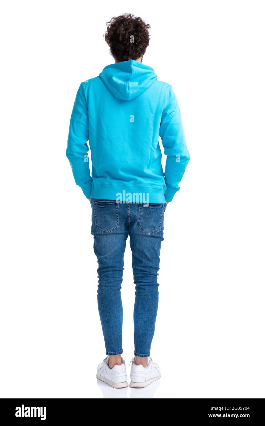 back view of curly casual man in blue hoodie holding hands in pockets and  waiting in line while posing against white background in studio Stock Photo  - Alamy