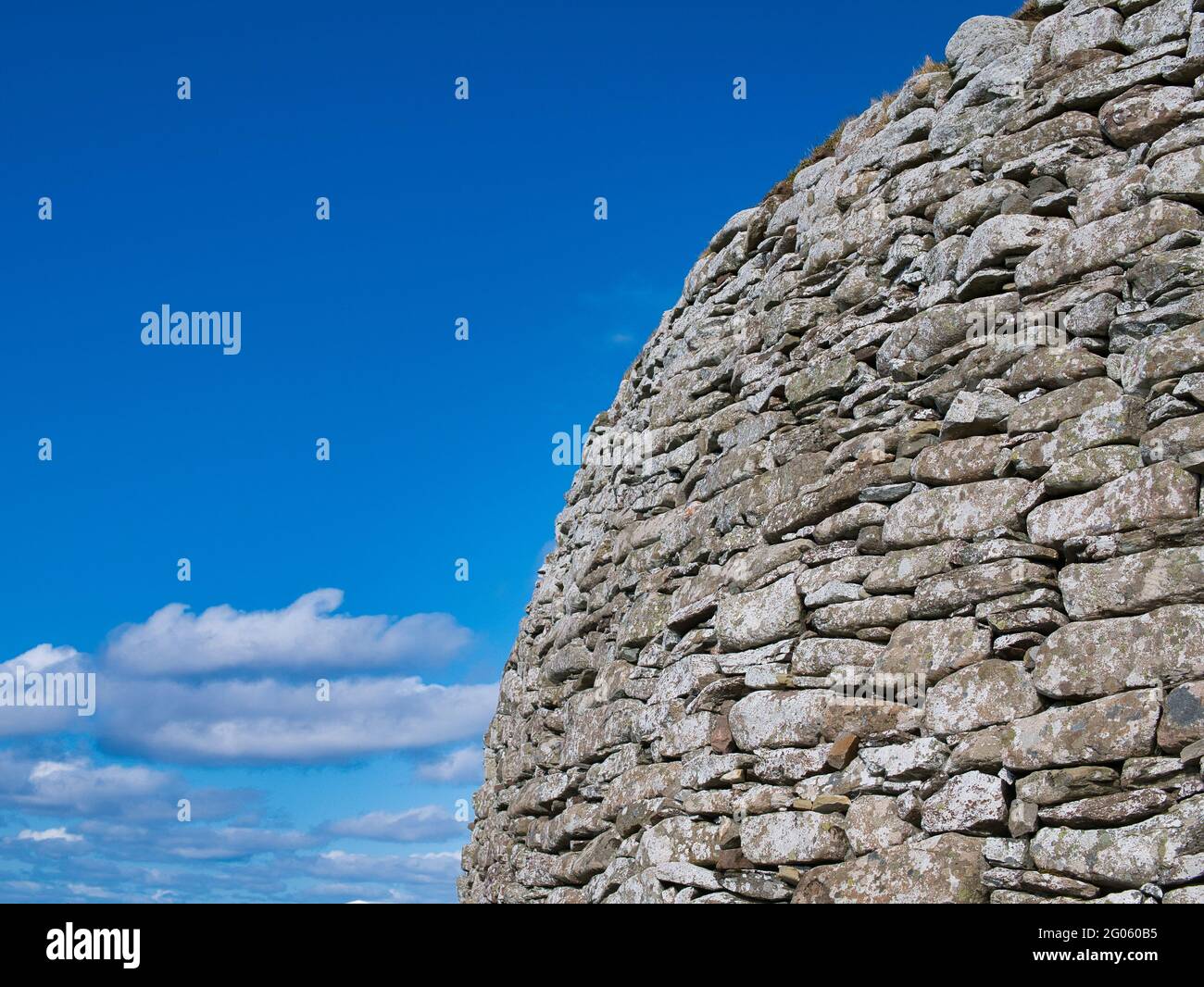 The dry stone wall structure of the Broch of Clickimin in Lerwick, Shetland, UK - taken on a sunny day with blue sky and white clouds Stock Photo