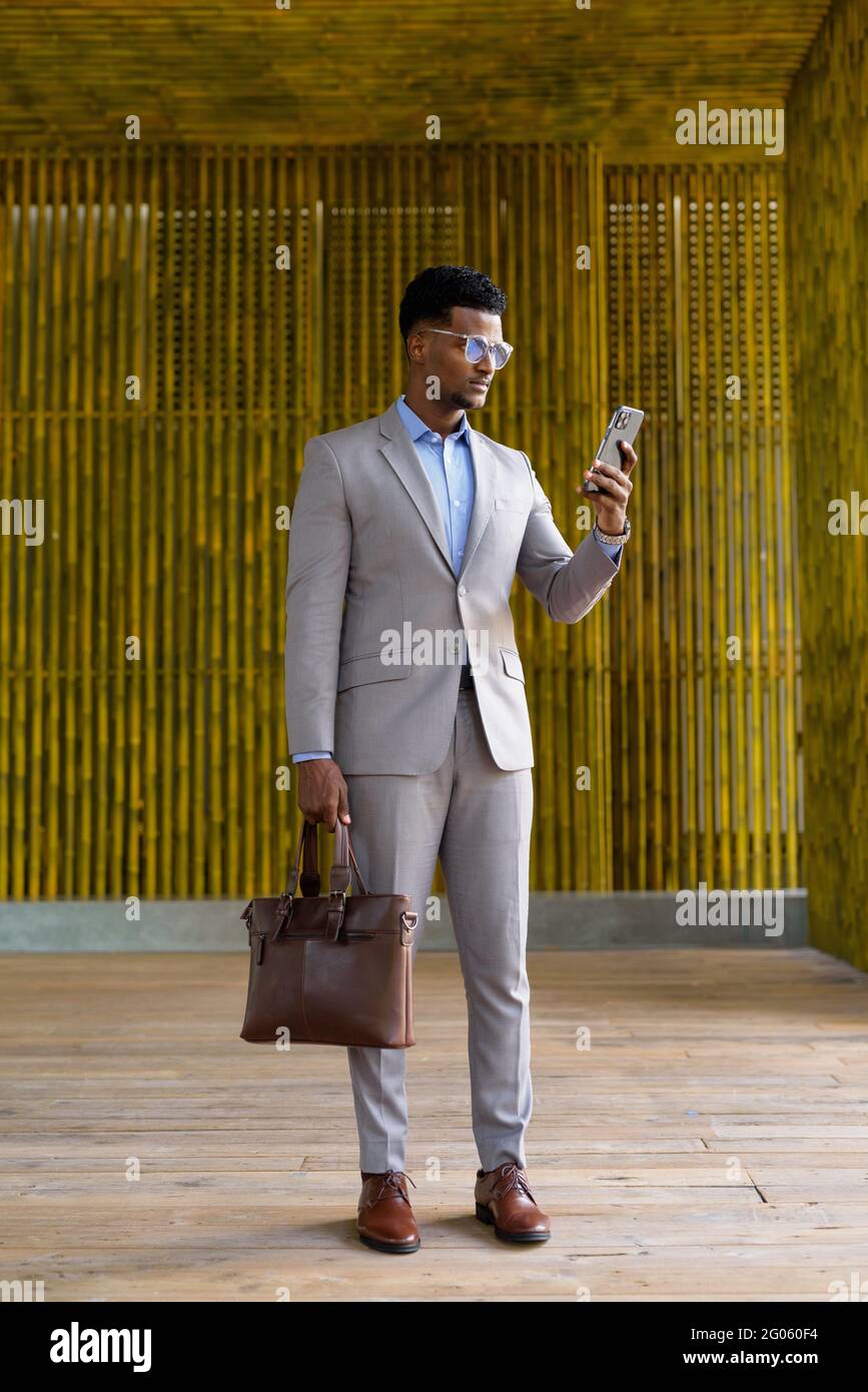 Portrait of handsome young African businessman wearing suit Stock Photo ...