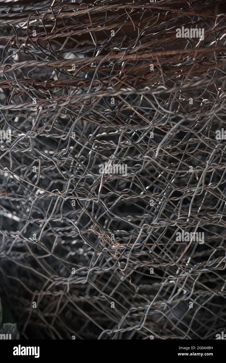Rolled up metal wire fence Stock Photo